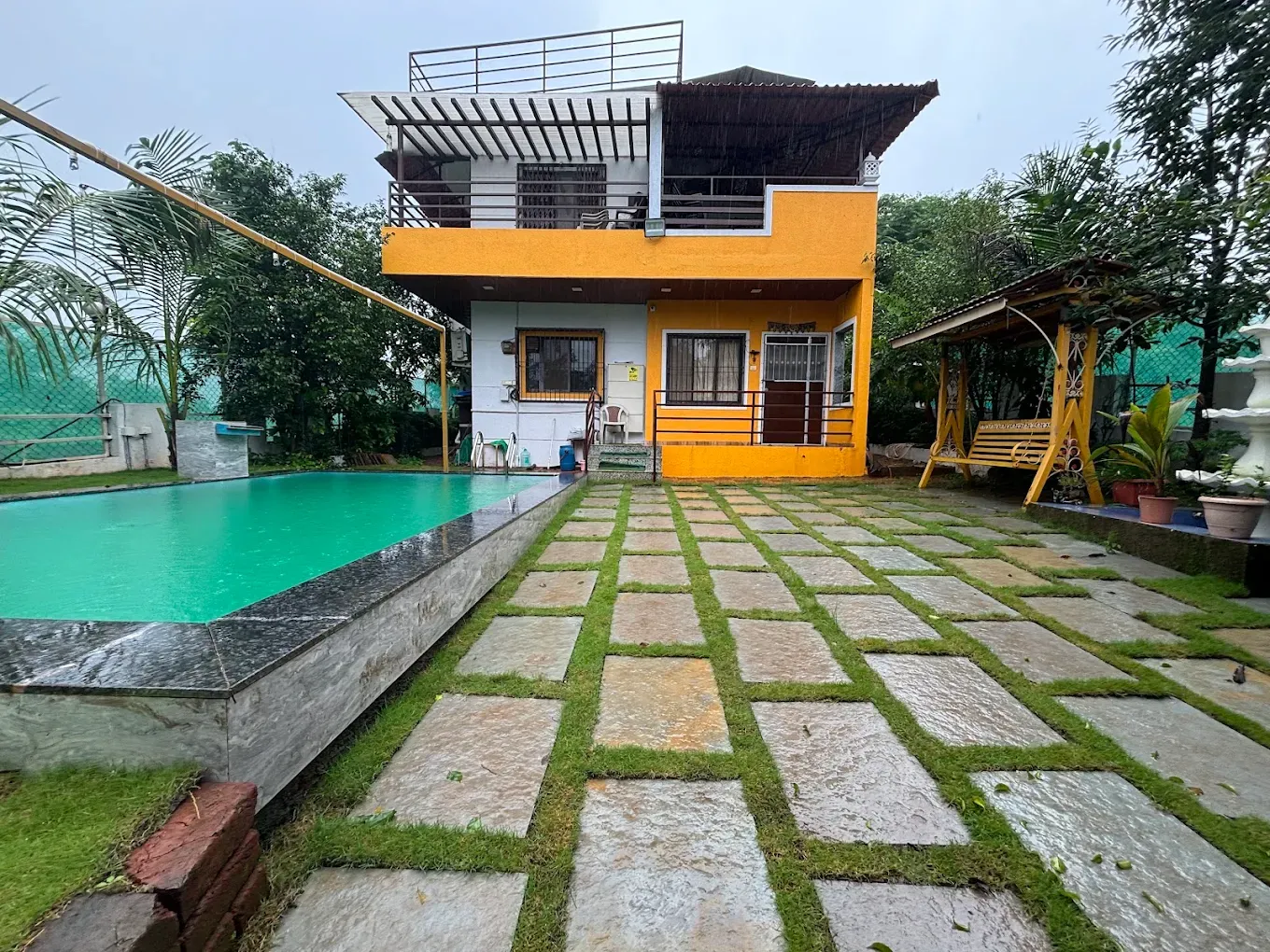 Rane’s Surekha Sadan 3 BHK fully furnished and AC Bungalow available on Rent near Kothimbe Karjat. Bungalow can accommodate 10-15 pax. Facilities Like Separate Terrace, Garden Area , small dhaba style area, swimming pool with rain dance Food options also available as part of package. Other Facilities: Indoor Games like Carrom, Chess, ludo Outdoor games like Cricket, Badminton