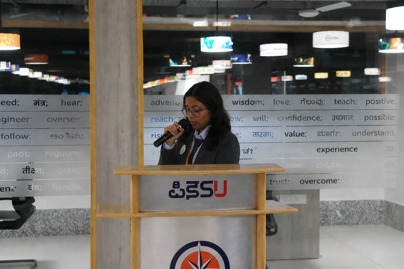 Confident professional woman smiling, dressed in business attire, expressing warmth and approachability.