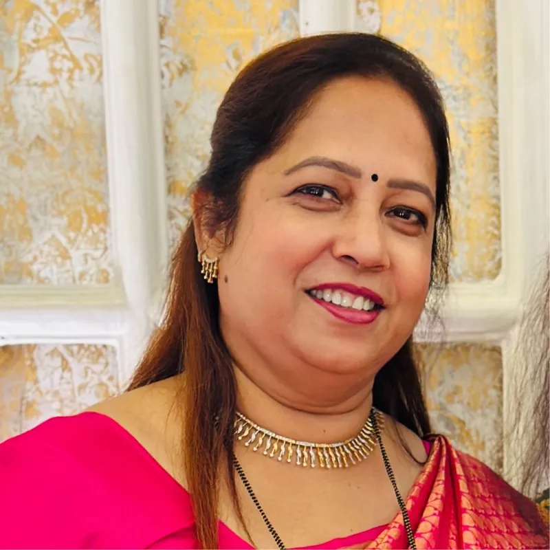 A group of adults attending an indoor workshop with a brick-wall backdrop.