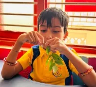 Indian teacher supporting children during autism learning session