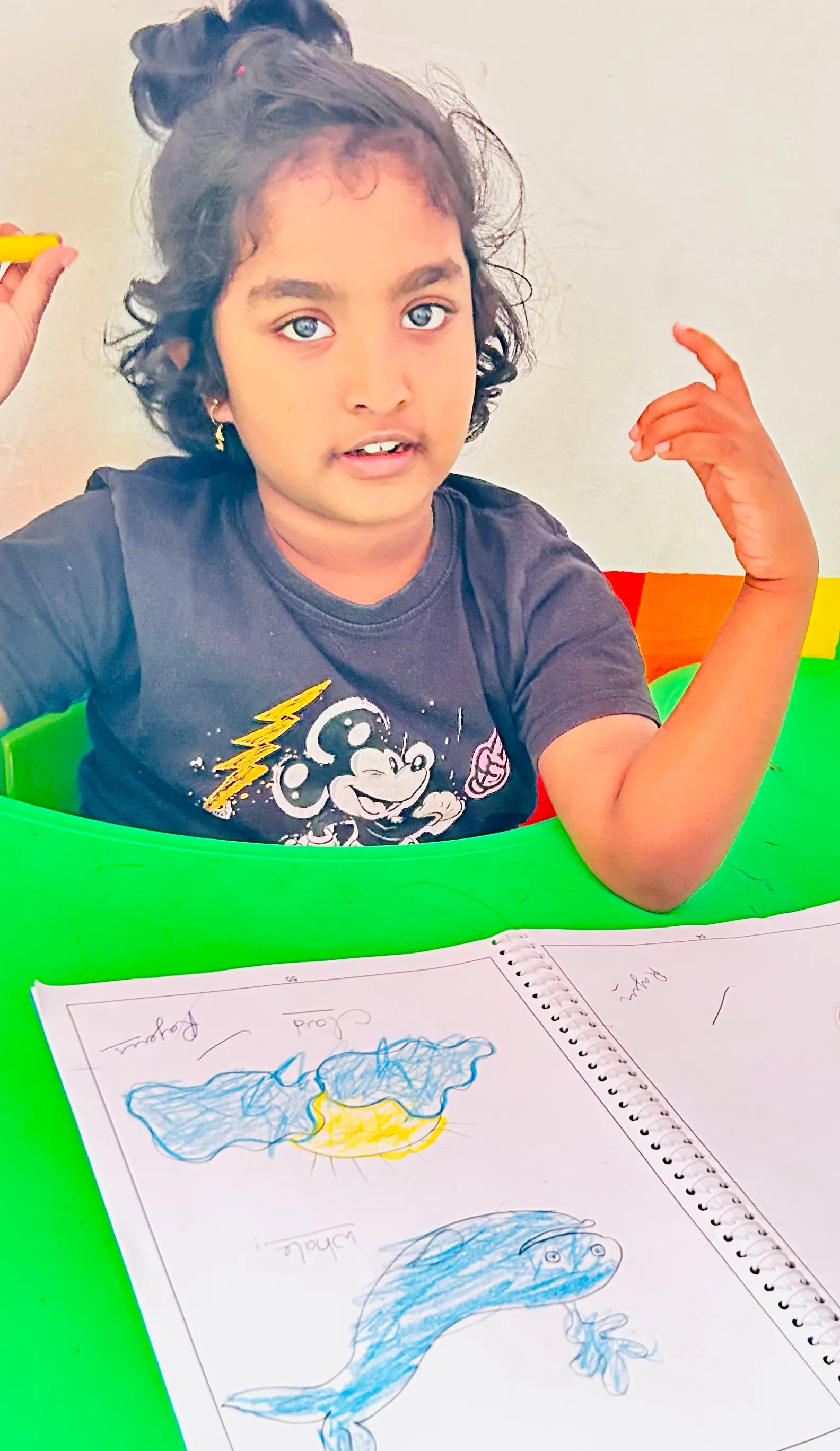 Indian teacher guiding children in early intervention classroom activity