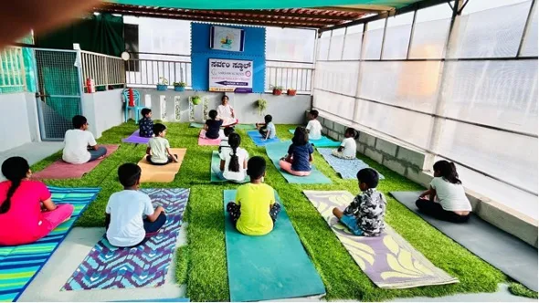 Indian children with teacher in speech and yoga therapy session