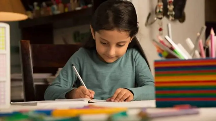 Children studying with focus at a desk