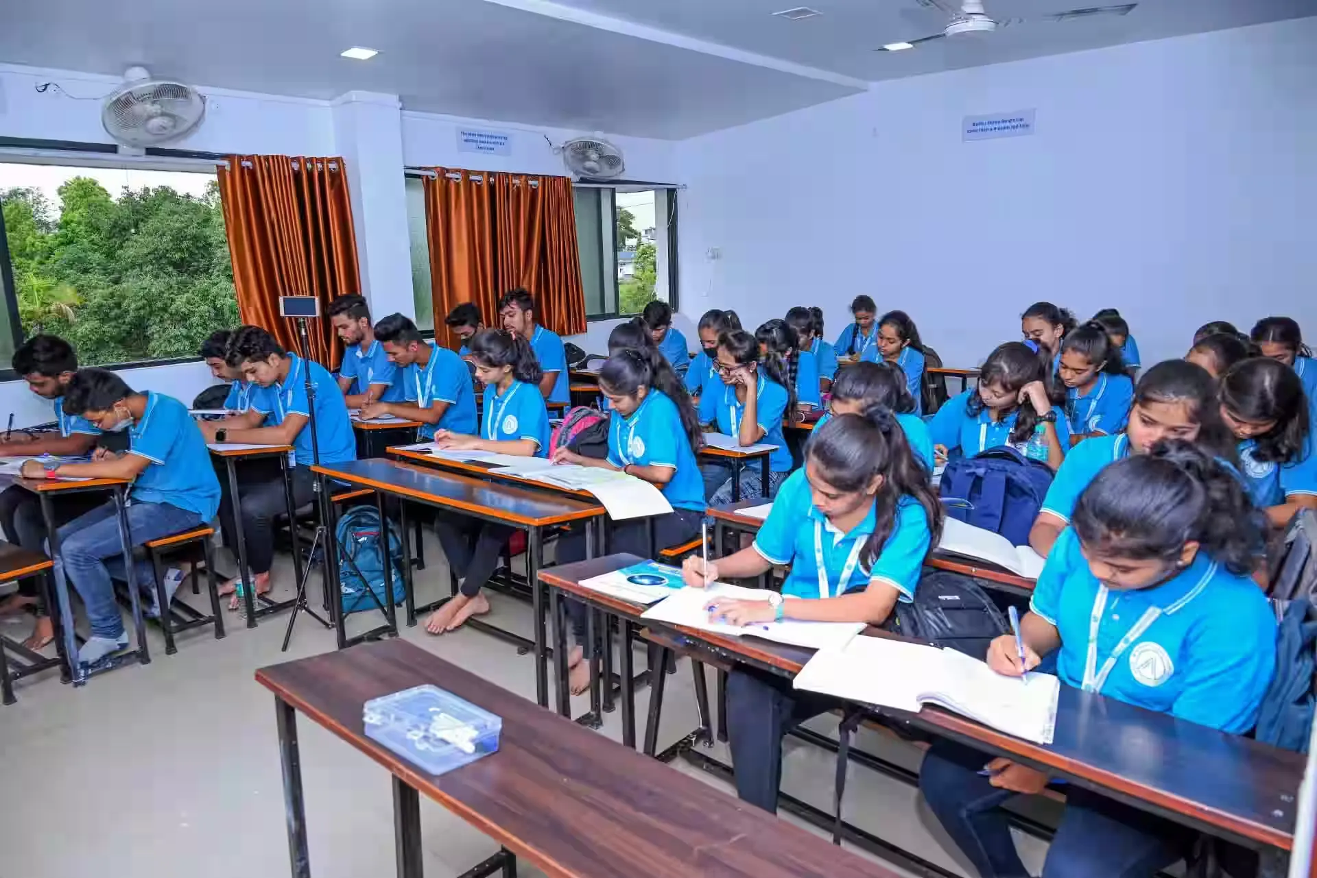 Students attending a lecture in a university classroom with an engaged professor.