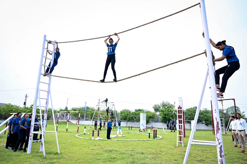 Students attending a lecture in a university classroom with an engaged professor.