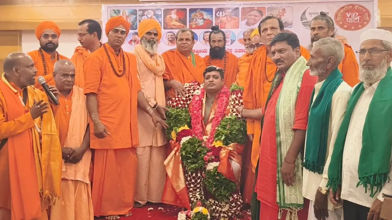 Group of men in traditional Rajasthani attire sitting indoors, showcasing cultural heritage.