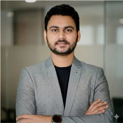 Confident business professional in suit holding documents in a bright office environment.